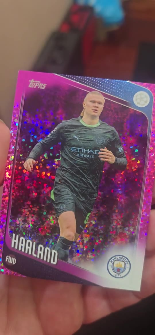 A close-up view records the surface of a sports card under changing light.